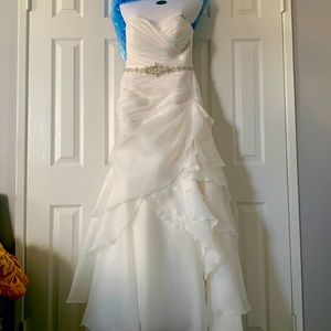 Beautiful off white Demtria cascading wedding dress.  Size 10, but altered.